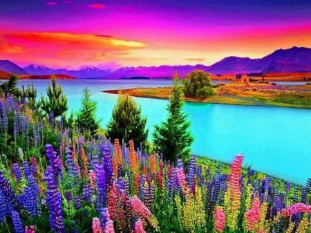 A lake with colorful flowers and mountains in the background.